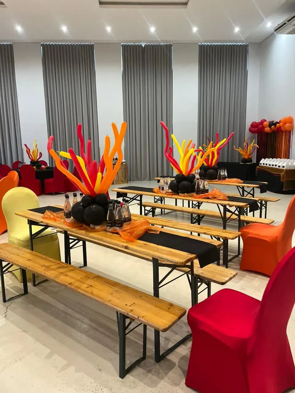 Beer bench sets with coloured balloon centrepieces at indoor birthday party event — beer bench hire Johannesburg Gauteng