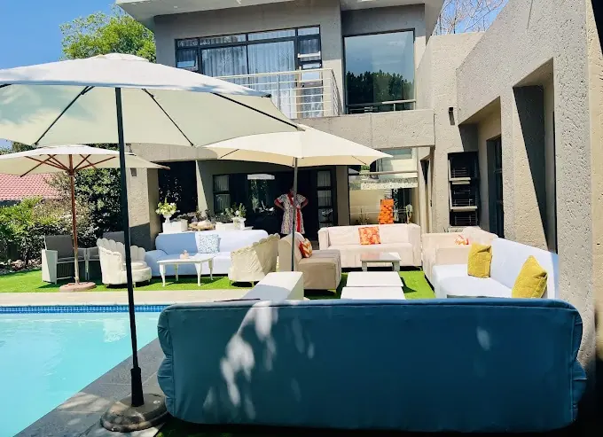 Poolside lounge seating with a large garden umbrella