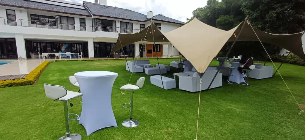 Garden stretch tent with white cocktail tables and chairs