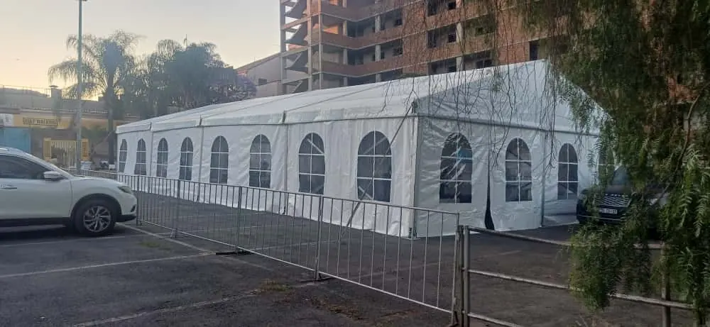 White marquee with arched window sidewalls in an urban venue