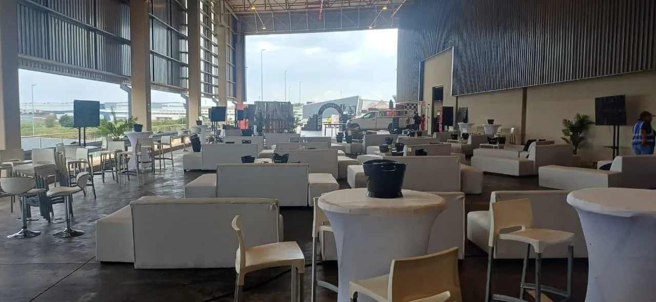 White lounge sofas and cocktail tables arranged inside a marquee