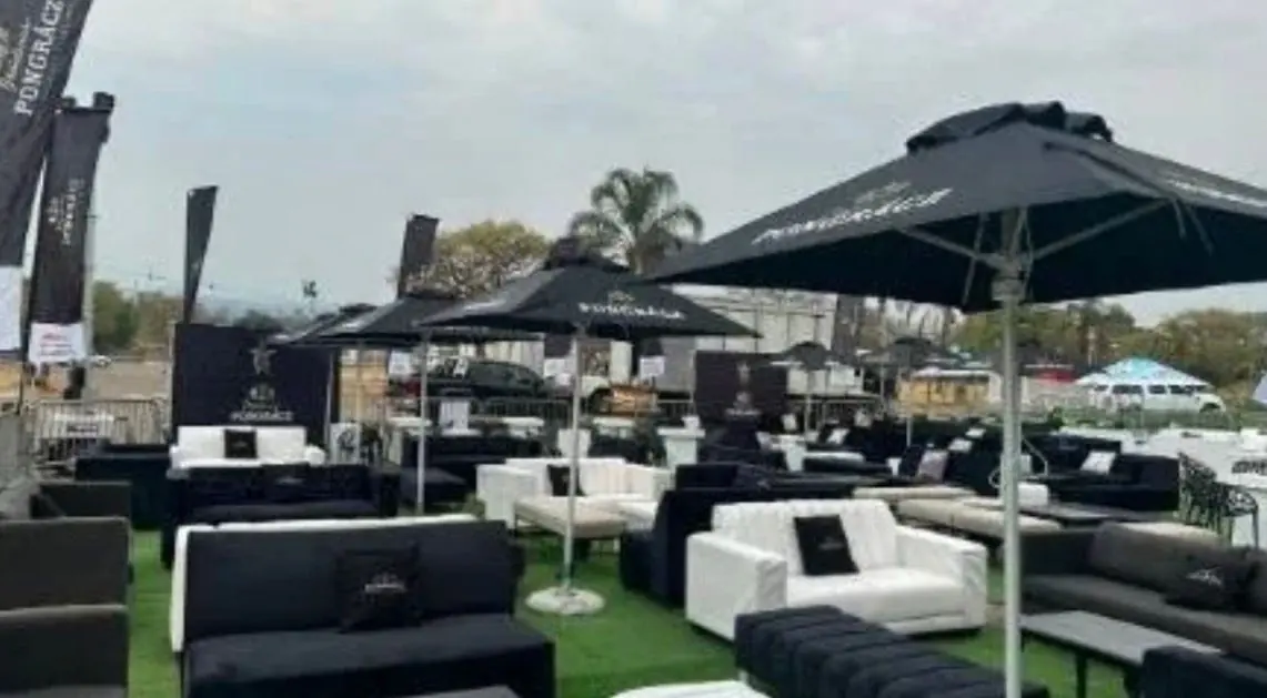 Outdoor lounge furniture beneath dark garden umbrellas