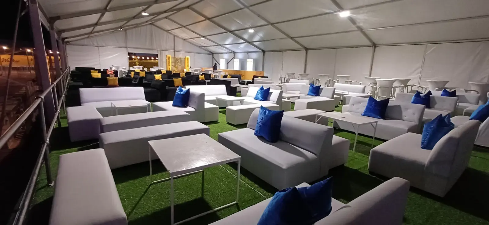 White couch hire and lounge furniture arranged inside a large marquee for a corporate event in Gauteng