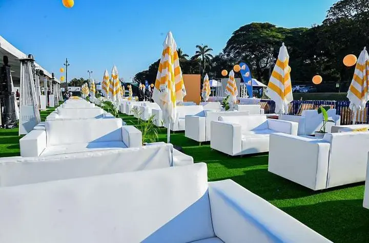 White sofa hire with outdoor lounge seating and umbrellas for an event in Gauteng