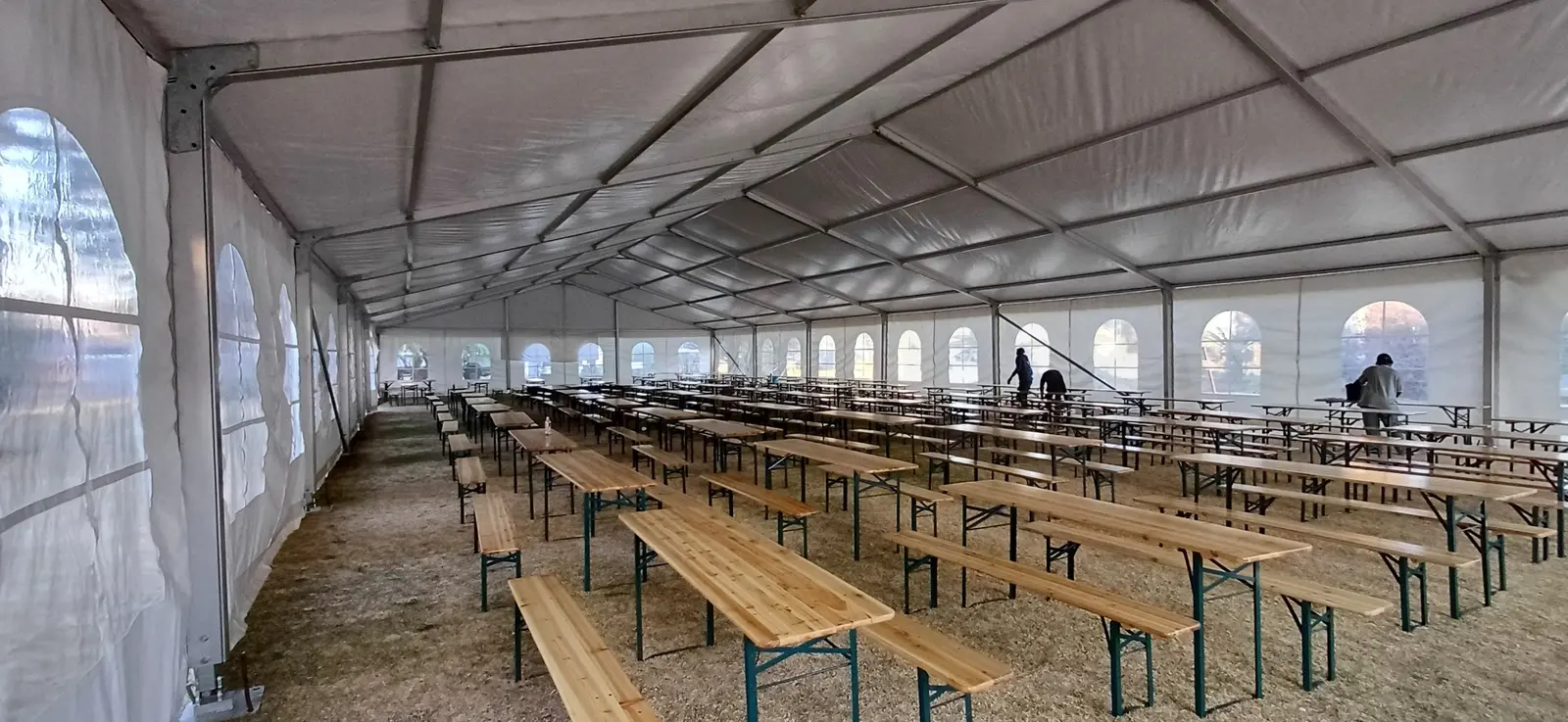 Beer bench and table sets arranged inside a large marquee for event hire in Gauteng, South Africa